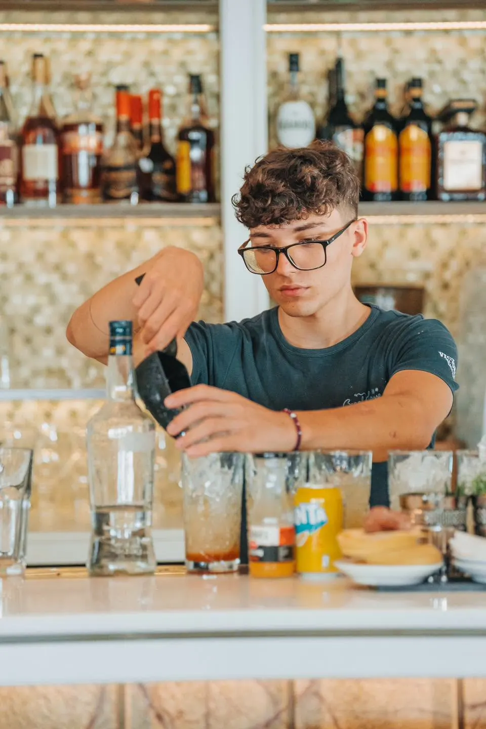 A bartender making a drink at the beach bar