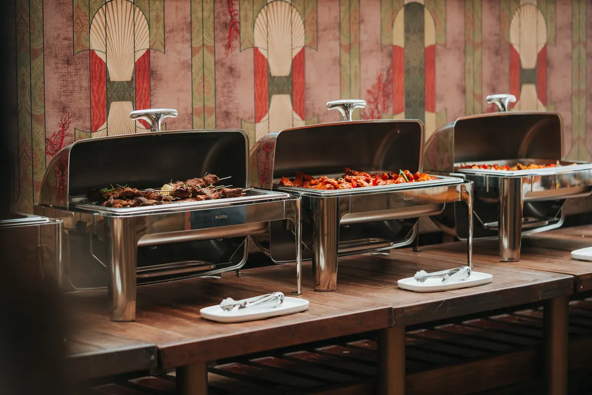 A buffet of grilled dishes laid out in the beach lounge