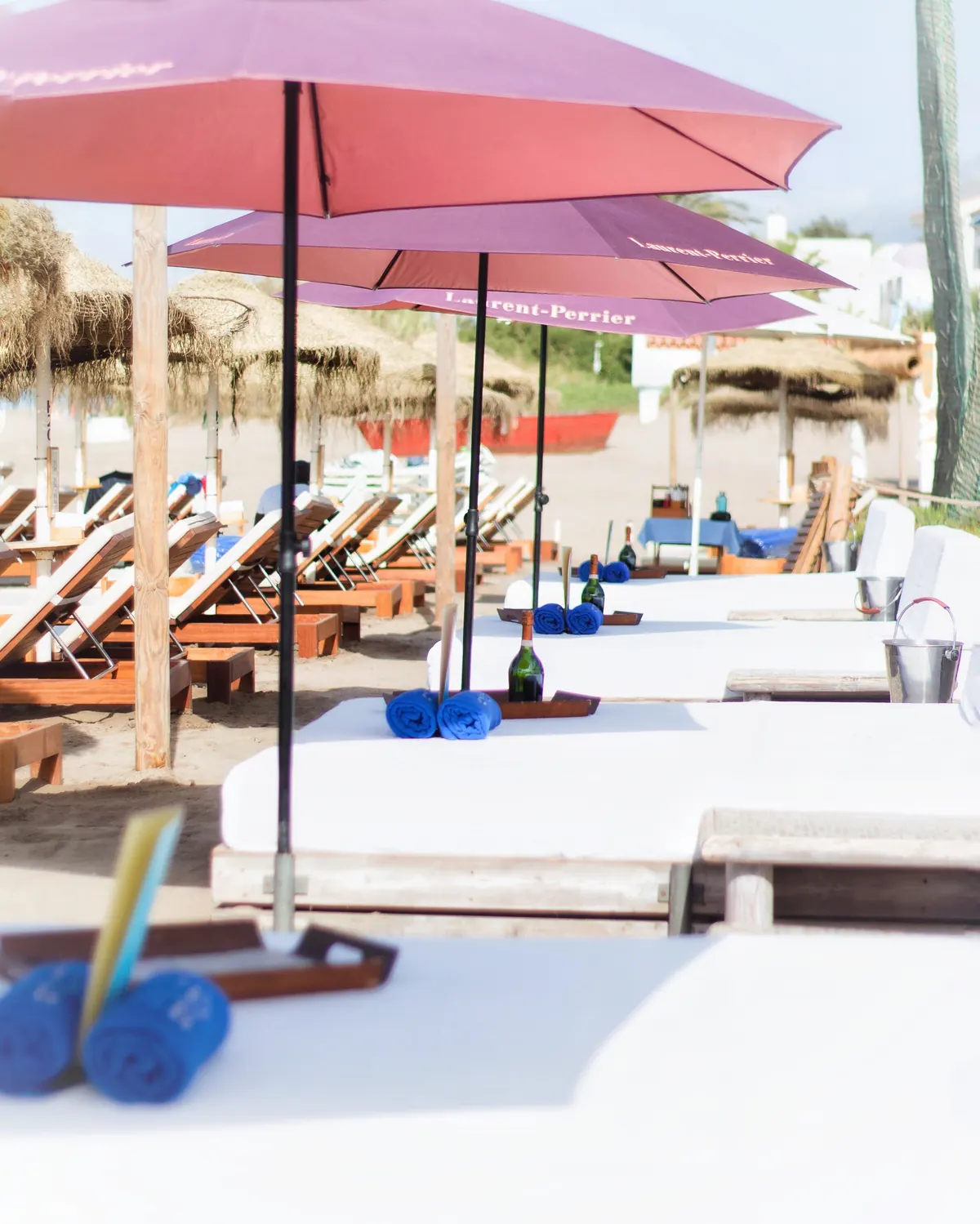 Cabana beds and sun beds stretching along the sand