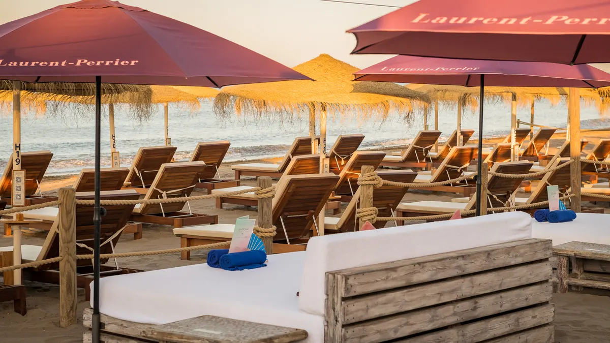 Cabana beds with cushions and towels on the beach