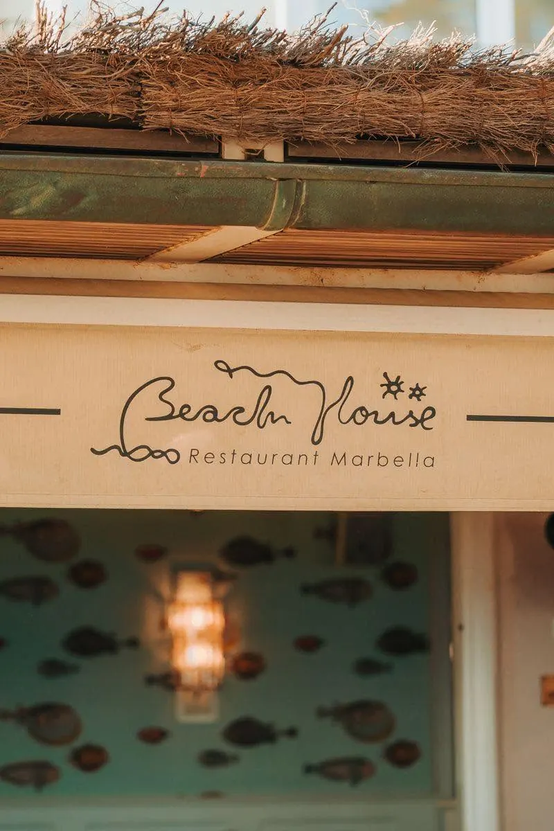 The Beach House Restaurant Marbella sign above the entrance