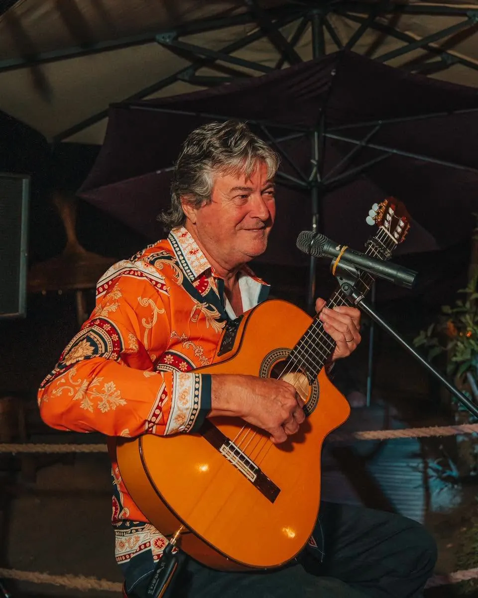 A guitarist singing on the terrace