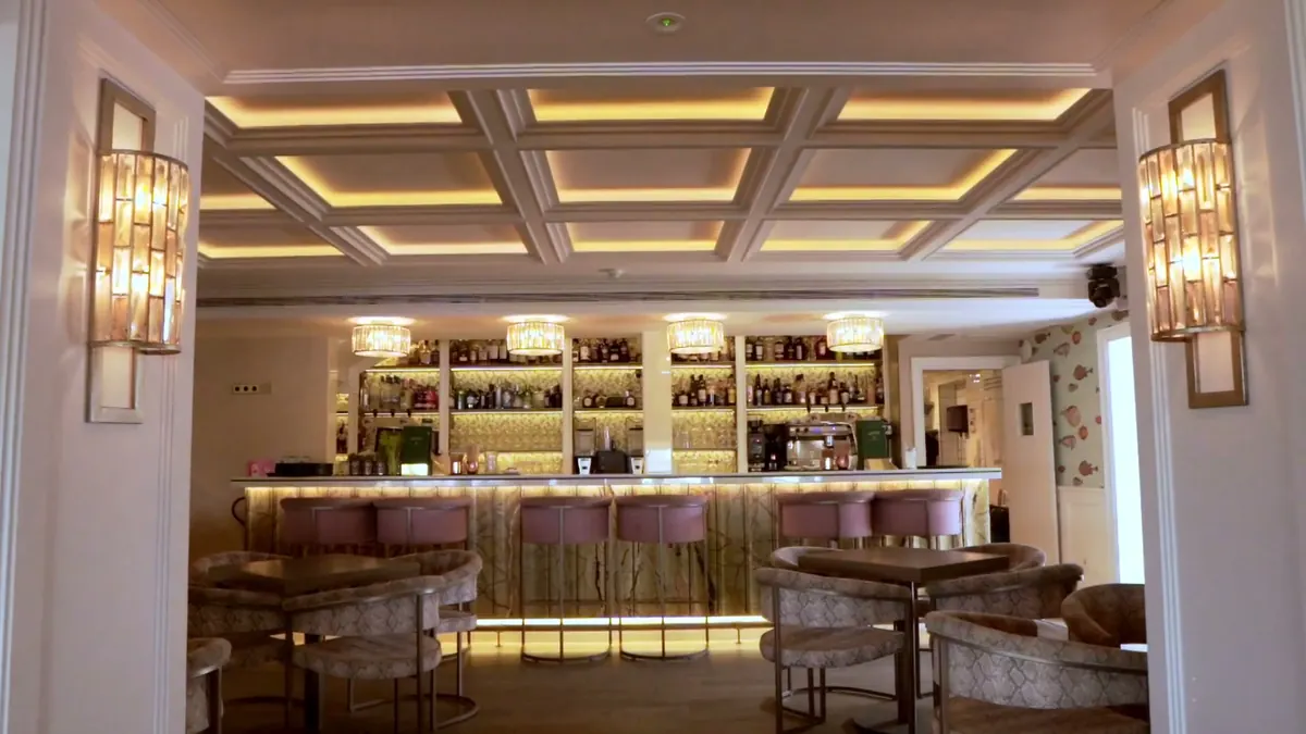 The interior cocktail bar under a coffered ceiling