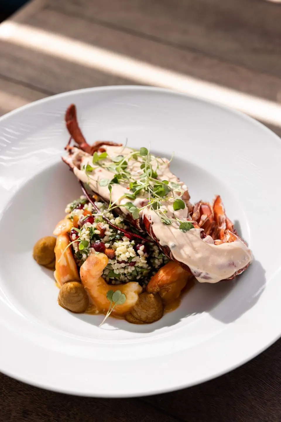 A lobster dish with grains and potatoes
