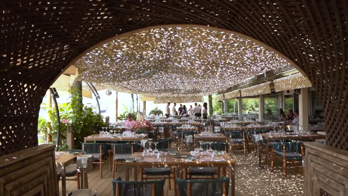 The restaurant terrace beneath its woven lattice canopy